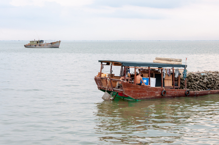 BEIHAI, CHINA - JUN, 2013: Heavily loaded old Chinese boatのeditorial素材