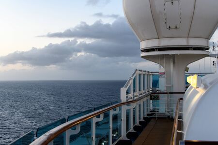 View from the deck of the cruise ship to the ocean. Sea horizon, clouds, blue tropical skyの写真素材