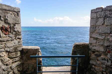 View of the tropical blue sea from the wall of the ancient fortressの写真素材