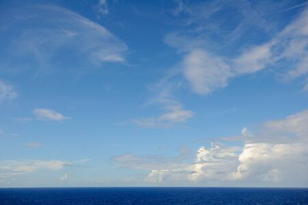 Sea horizon against the blue sky with clouds.の写真素材