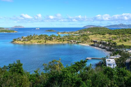View of the lagoon of a tropical island. Green trees, blue sea and blue sky with cloudsの写真素材