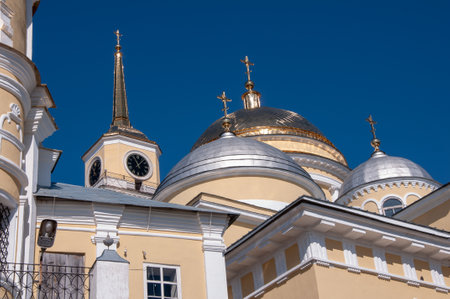 OSTASHKOV, RUSSIA - MAY, 2012: Crosses shining in the sun on the gold-covered domes of an Orthodox monastery Nilova Pustyn.のeditorial素材