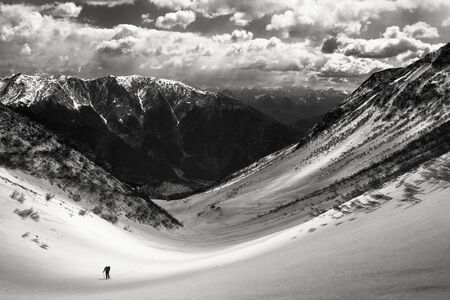 Solitary trekker in the majestic winter alpine landscapeの写真素材