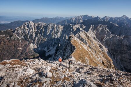 Hikers in the Alps contemplating the landscapeの写真素材