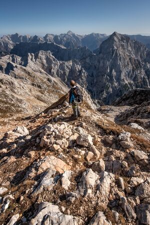 Hiker in the Alps contemplating the landscapeの写真素材