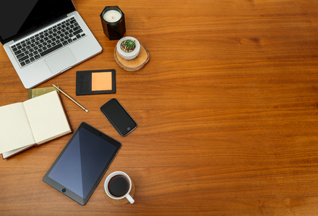 Office desk table, laptop, smartphone and other supplies with cup of coffee on wooden table . Top viewのeditorial素材