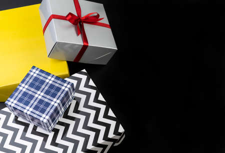 Gift boxes over black background with copy space.