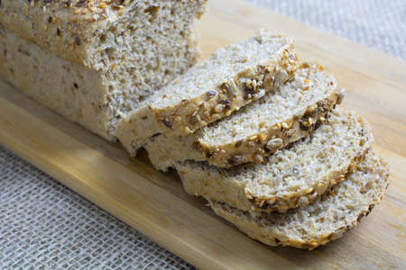 Sliced plain bread over wood background
