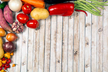 Vegetables over a wood table with room for textの写真素材