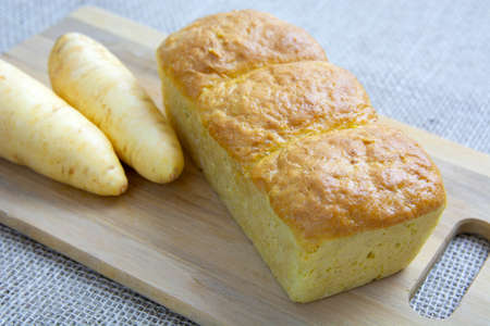 Mandioquinha bread over wood background