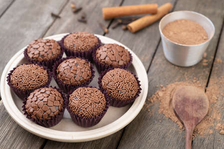 Typical brazilian brigadeiros, various flavors over wooden table.