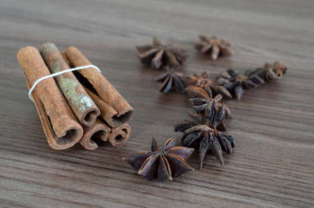Cinnamon sticks and star anise over wooden table