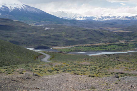 Road, snow mountains and a lake in Torres del Paine National Park, Chileの写真素材