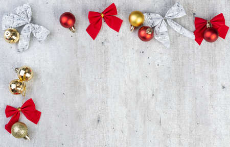 Christmas balls and gift bows over wooden table with copy space.の写真素材