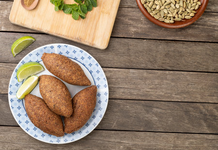 Traditional arabic fried kibbeh over wooden table with copy space. Typical brazilian snack.の写真素材