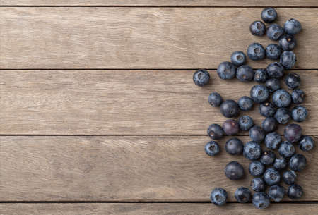 Blueberries over wooden table.の写真素材