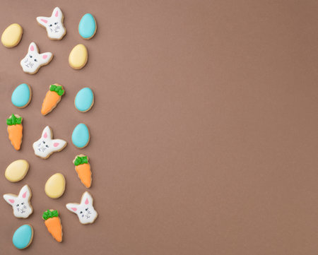 Easter cookies over brown background with copy space.