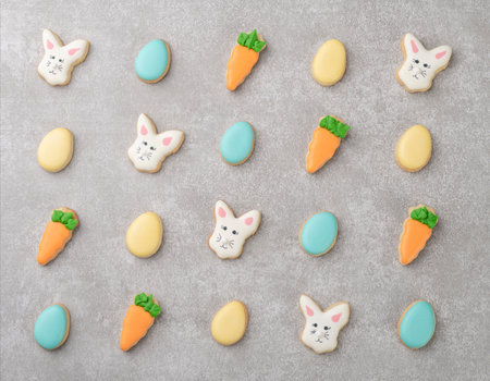 Assorted easter cookies over gray concrete background.