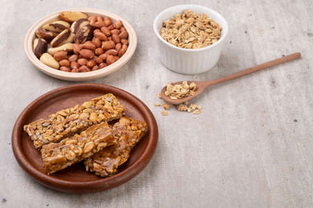 Homemade cereal bars with nuts, muesli, honey and copy space.の写真素材