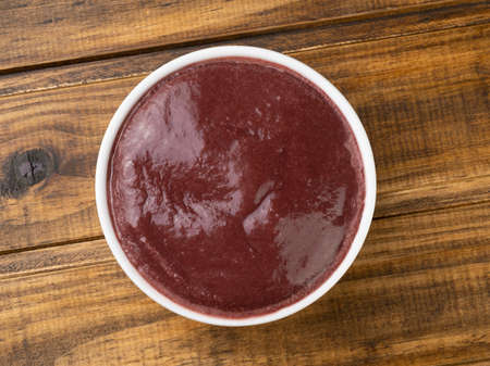 Brazilian typical acai bowl over wooden table.