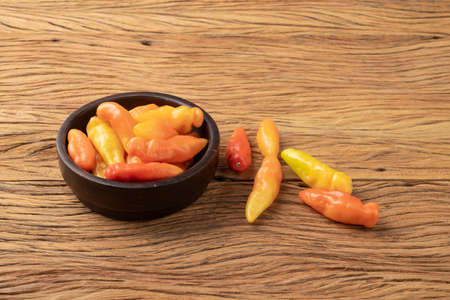 Orange scent / smell pepper on a bowl over wooden table.