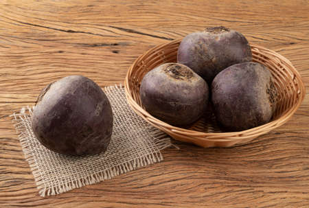 Beetroots in a basket over wooden table.