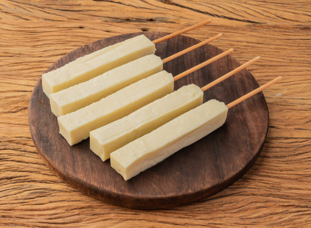 Rennet or Coalho cheese on a wooden board.の写真素材