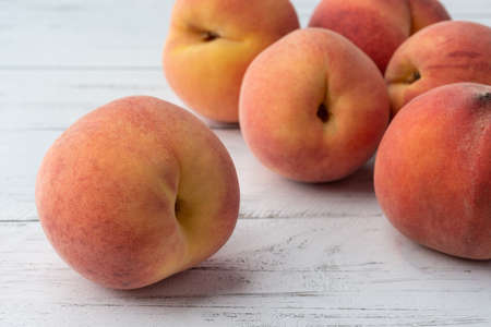 A group of peaches over wooden table.の写真素材
