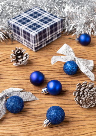 Gift box, christmas balls and bow over wooden table.の写真素材