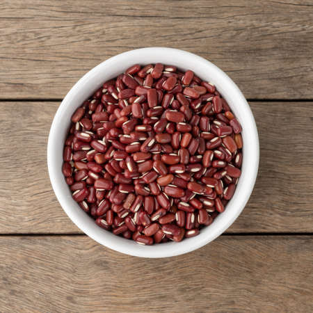 Azuki beans in a bowl over wooden table.