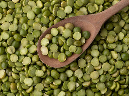 Closeup, top view of raw dried green peas in a spoon.の写真素材