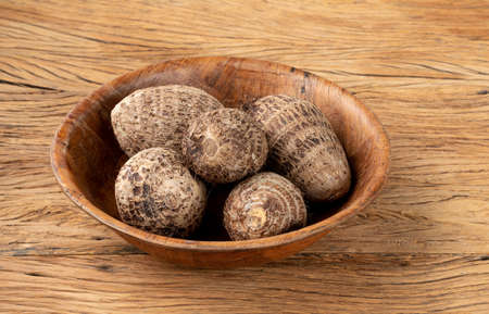 Raw yams or yams on a bowl over wooden table.の写真素材