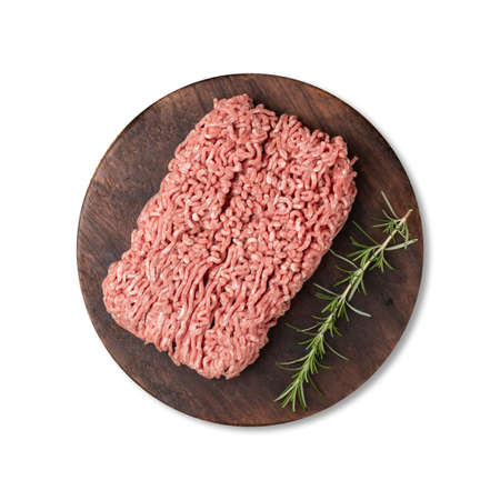 Ground beef over wooden board with seasonings isolated over white background.