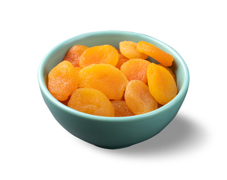 Dried apricots in a bowl isolated over white background.の写真素材