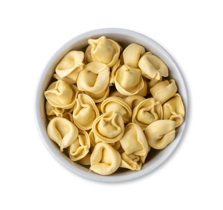 Uncooked cappelletti or tortellini on a bowl isolated over white background.の写真素材