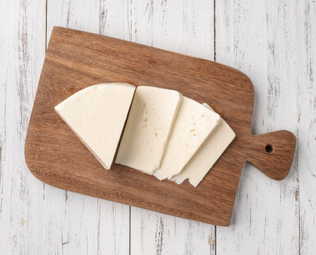 Artisanal fresh Canastra cheese with over wooden board.