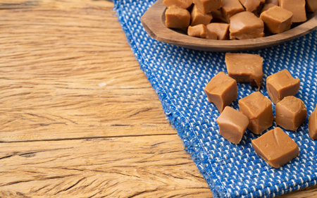 Dulce de leche or dulce de leche, traditional south american milk candy over wooden table with copy space.の写真素材