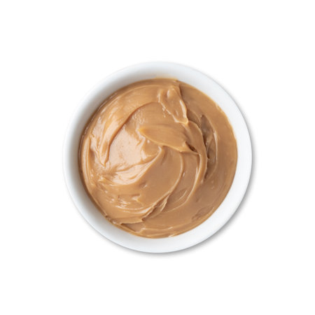 Dulce de leche, traditional brazilian creamy milk sweet isolated over white background.