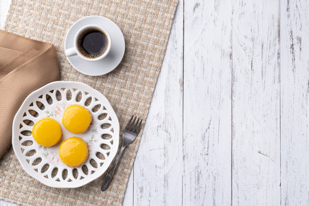 Quindim, traditional egg and coconut brazilian dessert with coffee and copy space.の写真素材