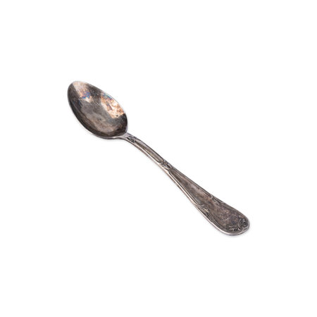 Old decorated metal tea spoon isolated over white background.の写真素材