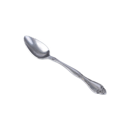 Old decorated metal dessert spoon isolated over white background.の写真素材