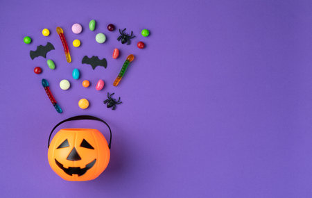Assorted colorful candies over purple background with copy space.の写真素材