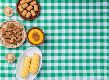 Typical brazilian june festival food over plaid fabric. June celebration.