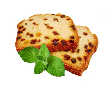 Two pieces of fruitcake and green mint isolated on white backgroundの写真素材