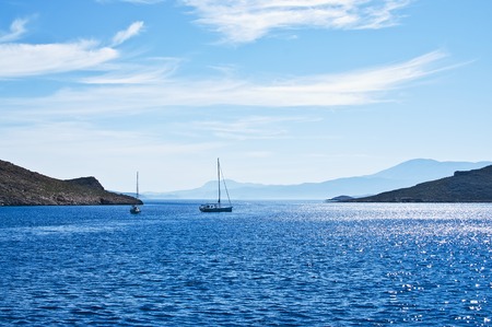 Sailing boat on Aegean sea near Nisyros Island. Greece. Europe