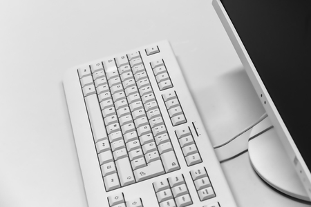 Computer keyboard and monitor on a deskの写真素材