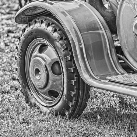 front wheel of old tractor - black and white
