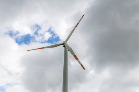 wind turbine against blue sky with white clouds in the wind farm.の写真素材