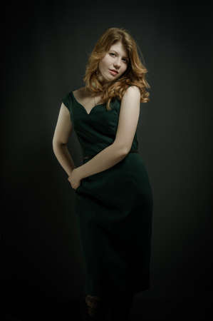 Beutiful young woman  with red hairs in green dress.の写真素材