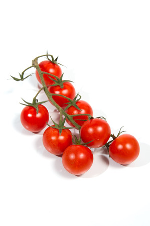 Fresh cherry tomatoes on vine  Isolated の写真素材